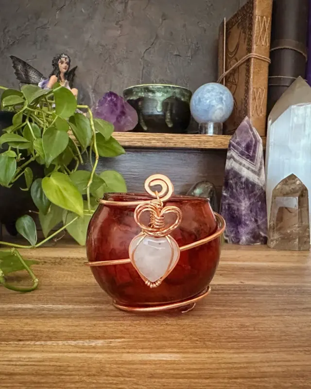 Designed to support spells of romance, self-love, and deep emotional healing, this red candleholder features a rose quartz heart and a wire-wrapped heart charm. 

Rose quartz opens the heart chakra and invites gentle yet powerful love to flow into your life. 

Magickal Focus: Love, Passion, Romance, and Emotional Connection Use during love spells, passion rituals, or any time you want to open your heart to love's many forms-whether romantic, self-directed, or spiritual. 

Light your candle with intention and let the flame carry your desire into the universe, supported by blessed elements and magickal correspondences.

This and many other magickal creations available at the shop, link in bio

https://herenchantedcreation.etsy.com/?section_id=32988552

#magicalcreations #makingmagic #makeeverydaymagic #magicaltools #herenchantedcreations #candleholders #everydaywitchcraft #everydaymagic #ritualtools #witchylife