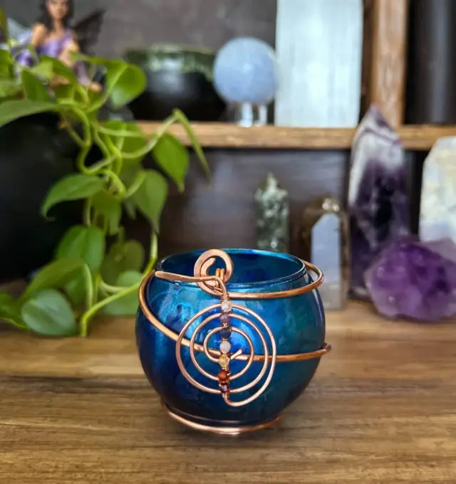 Let the light of this healing candle guide you back to wholeness. 

Seven crystals align with each chakra, working together to restore your energy and soothe your spirit. 

This blue spell candleholder is adorned with crystals for all seven chakras—from grounding garnet to crown-activating clear quartz. 

The Reiki ChoKuRei charm enhances energy flow, making this a powerful tool for Reiki, meditation, and energetic healing work.

A sacred companion for any healing journey.

#magicalcreations #magicalsolutions #makingmagic #makeeverydaymagic #magictools #magicaltools #everydaywitchcraft #everydaymagic #enchantedcreations #candleholders #chakrahealing #chakramagic #reikienergy #ritualtools #herenchantedcreations